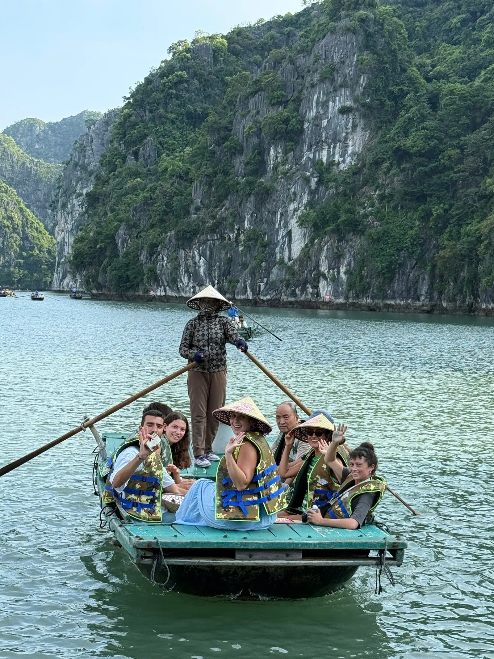 Guests in a bamboo boat rowed by a local boatwoman in Lan Ha Bay