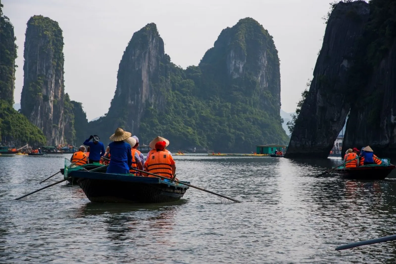 Rowing boats among the limestone karsts of Halong Bay