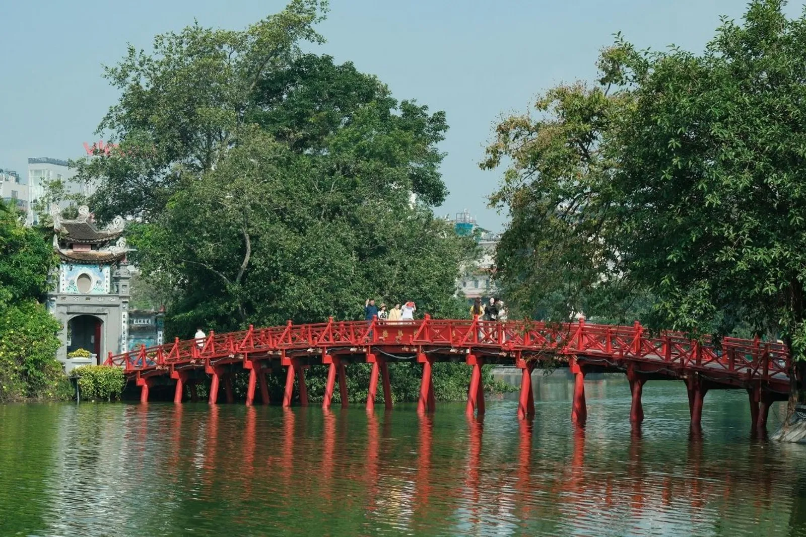 The red The Huc Bridge to Ngoc Son Temple on Hoan Kiem Lake, Hanoi